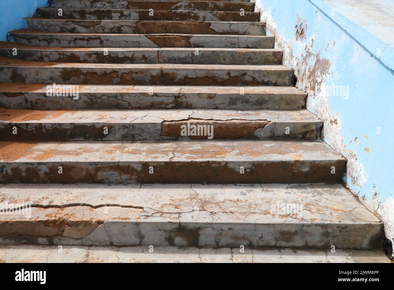 Weather damage of concrete. Flaking concrete on beach stairs. Problem