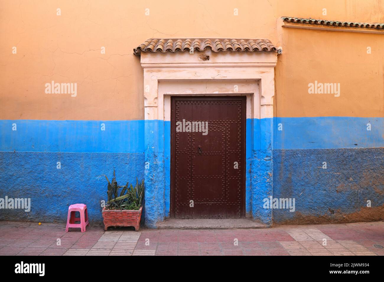 Taroudant city, Morocco. Blue and orange walls. Traditional riad door ...