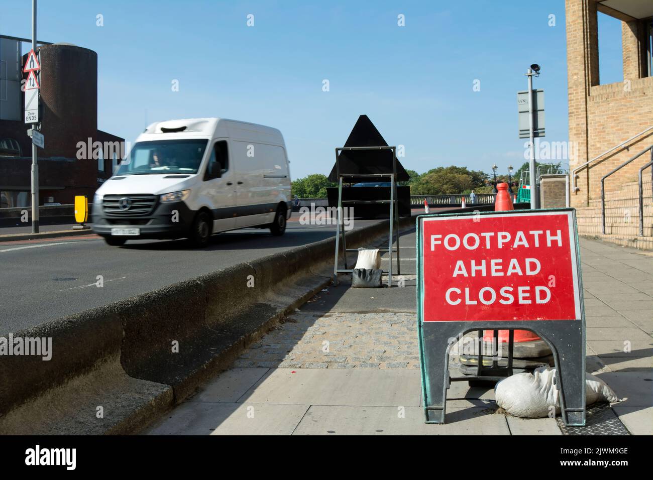british temporary footway sign warning footpath ahead closed, on the approach to kingston bridge, kingston, surrey, england, as a white van passes Stock Photo