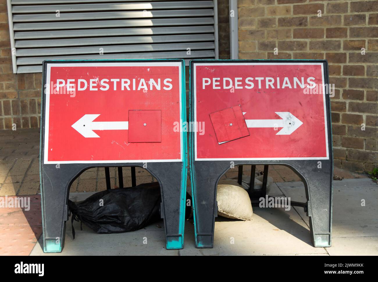 british temporary signs indicating pedestrians may turn left or right, although there does not appear to be any other option, kingston, england Stock Photo