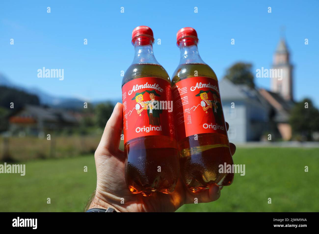 CARINTHIA, AUSTRIA - AUGUST 9, 2022: Almdudler carbonated soft drink in plastic bottles. The sweetened drink with herbal extracts is one of most recog Stock Photo