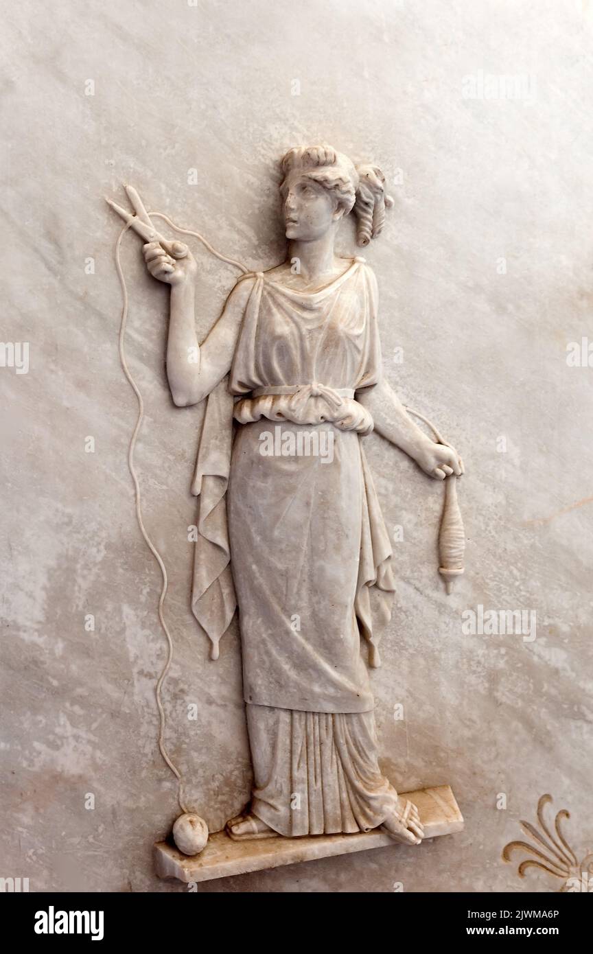 Bas relief of Atropos, one of the three Moirai, goddesses of fate and destiny, cutting the thread of life Stock Photo