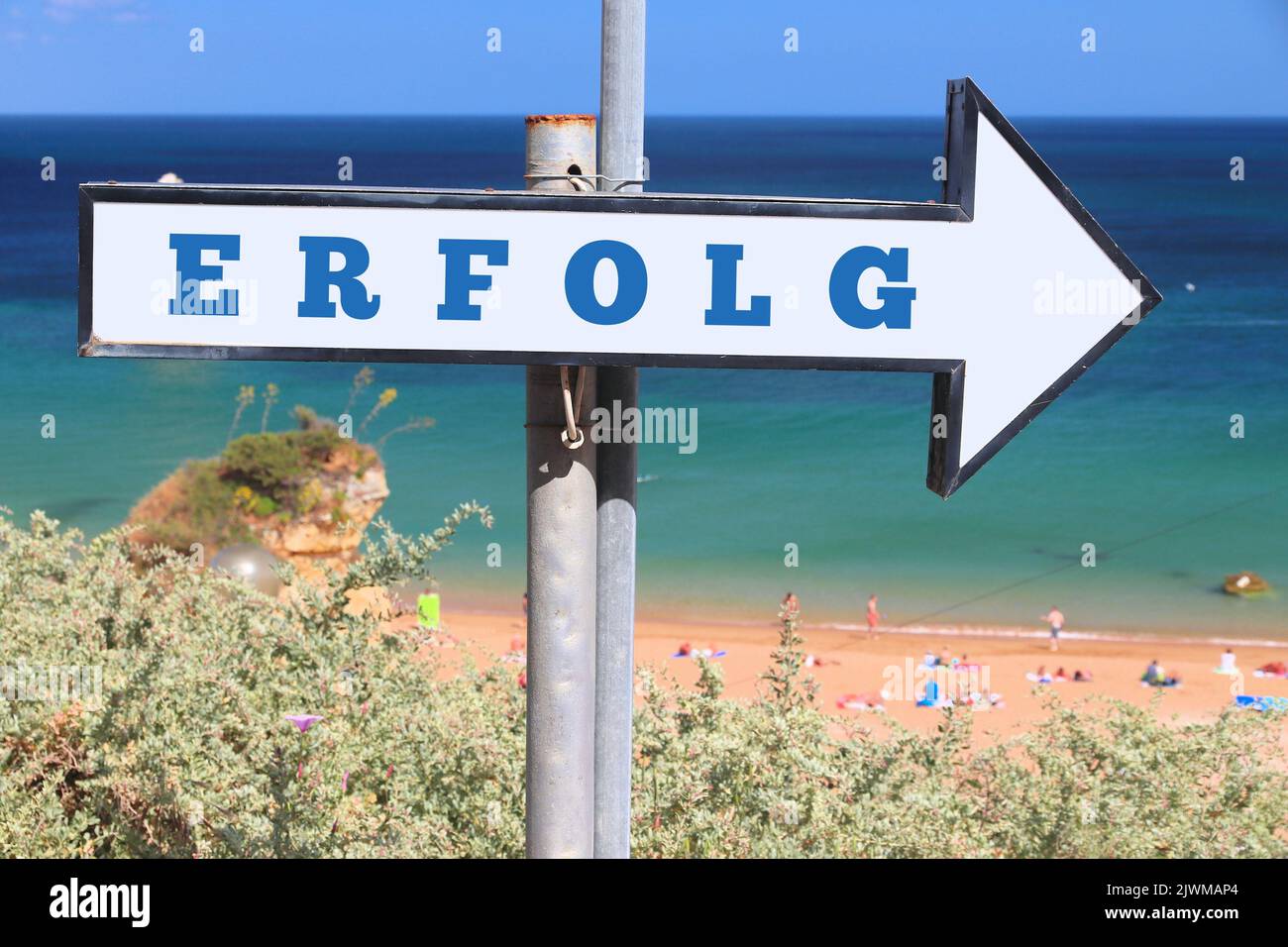 Erfolg - success word in German language. Beach sign text. Stock Photo