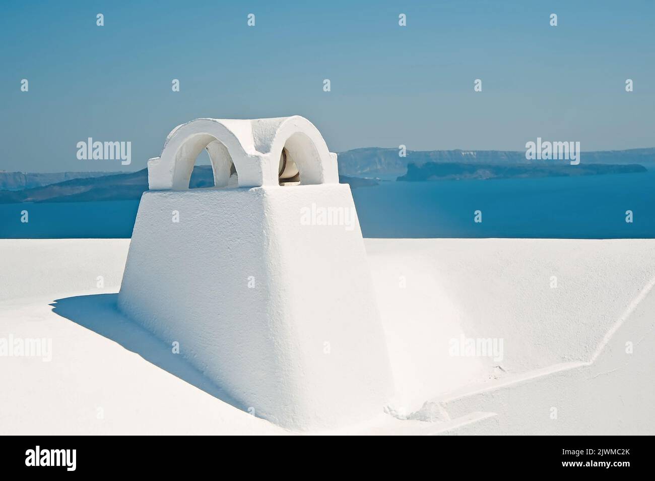Chimney in Oia on Santorini island in Greece with caldera view at background Stock Photo