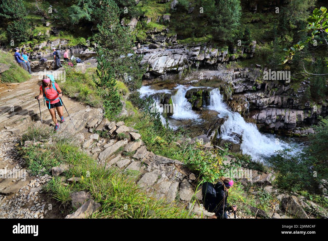 PYRENEES, SPAIN - SEPTEMBER 26, 2021: Hikers visit watefalls along Senda de Los Cazadores hiking trail in Ordesa y Monte Perdido National Park in Pyre Stock Photo
