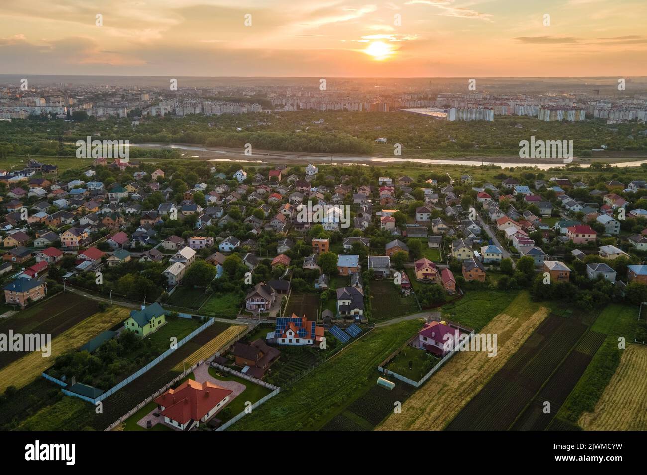 Aerial view of residential houses in suburban rural area at sunset ...