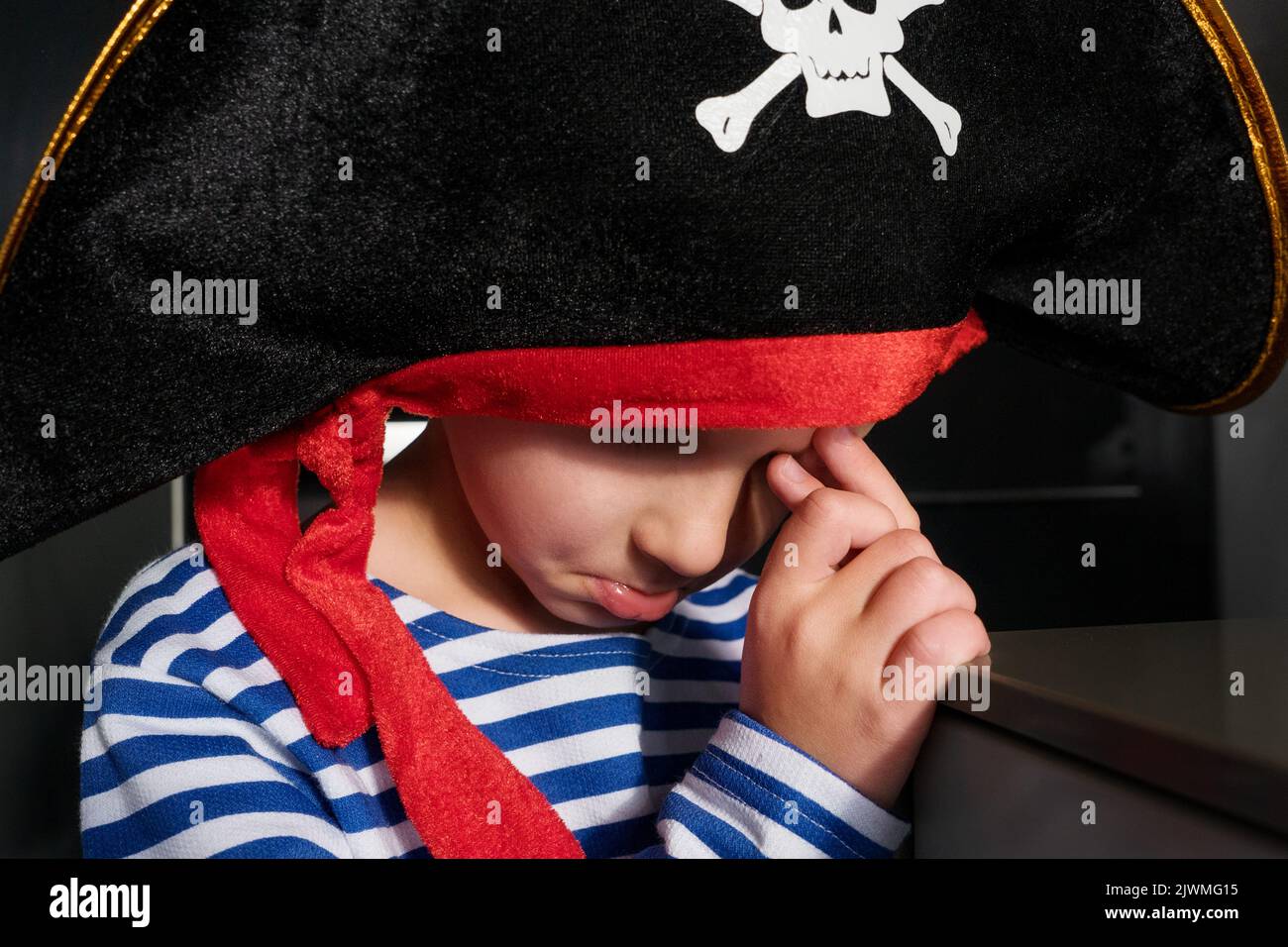 portrait of offended boy in pirate costume crying at party Stock Photo