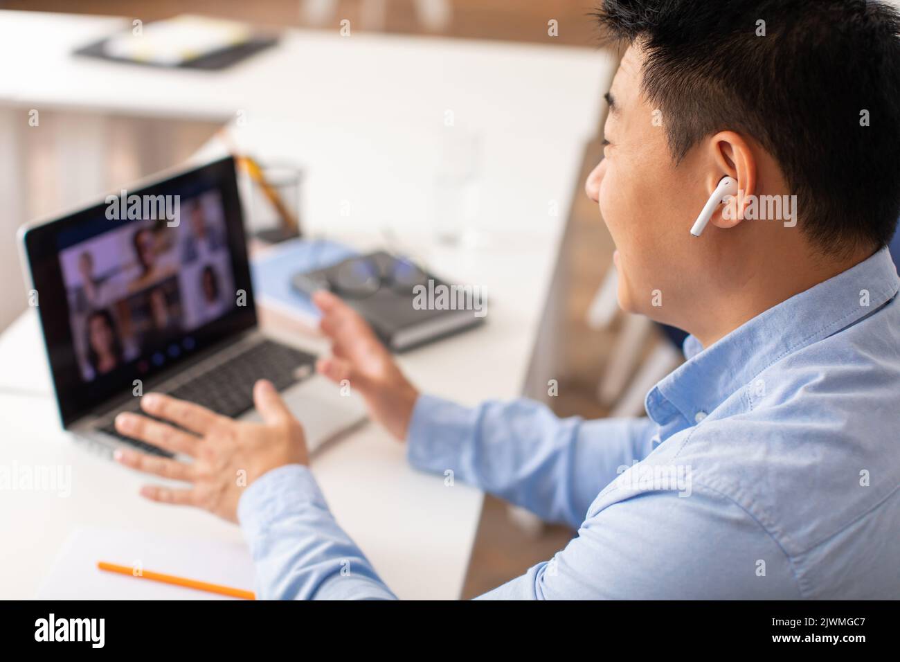 Korean Male Teacher Having Video Call Via Laptop At Workplace Stock ...