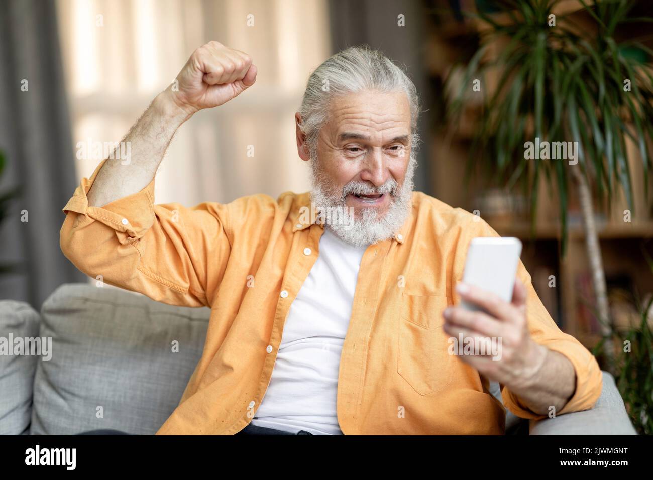 Happy excited old man mobile hi-res stock photography and images - Alamy