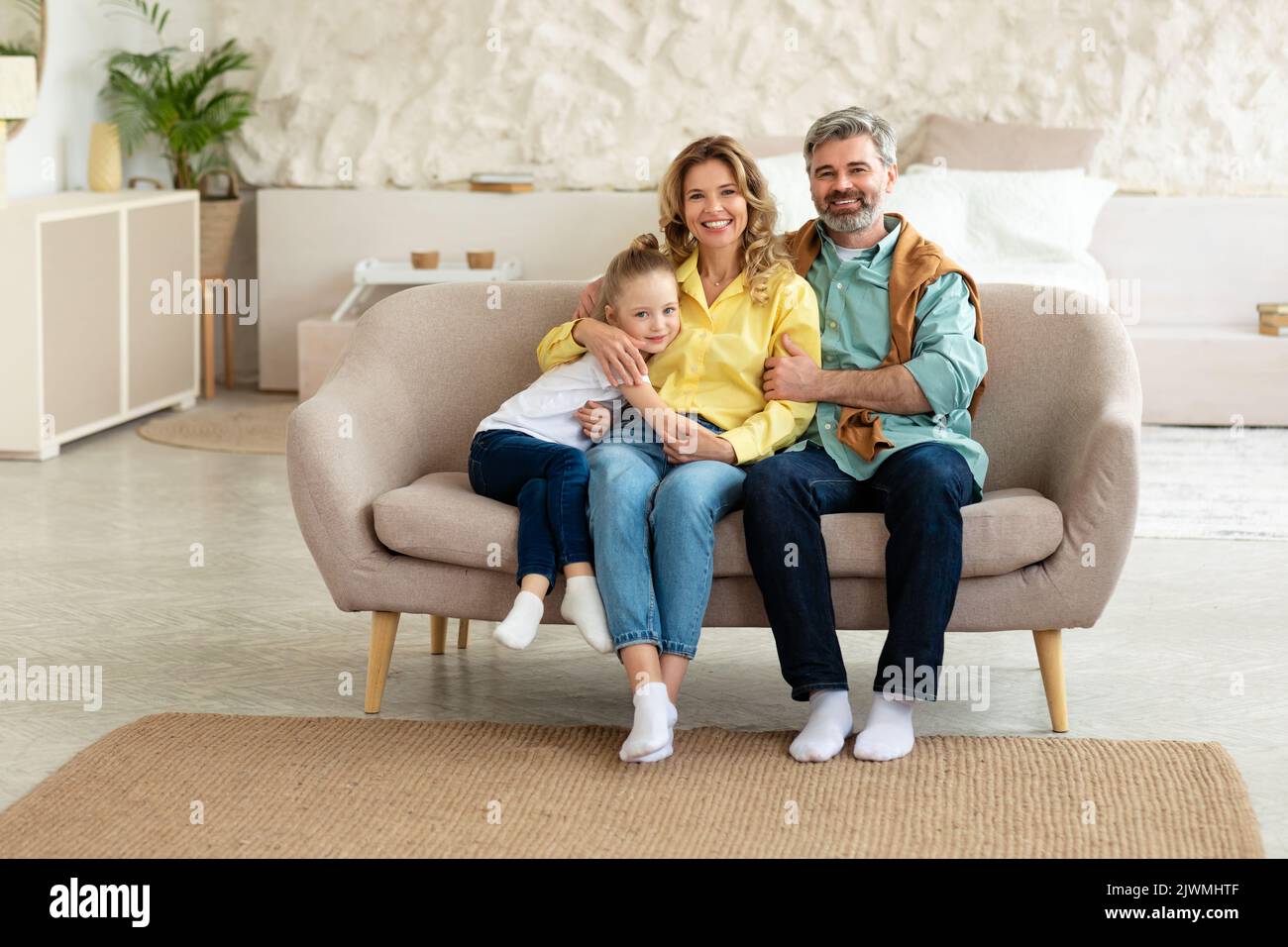 Cheerful Family Sitting On Couch In Modern Living Room Indoor Stock ...