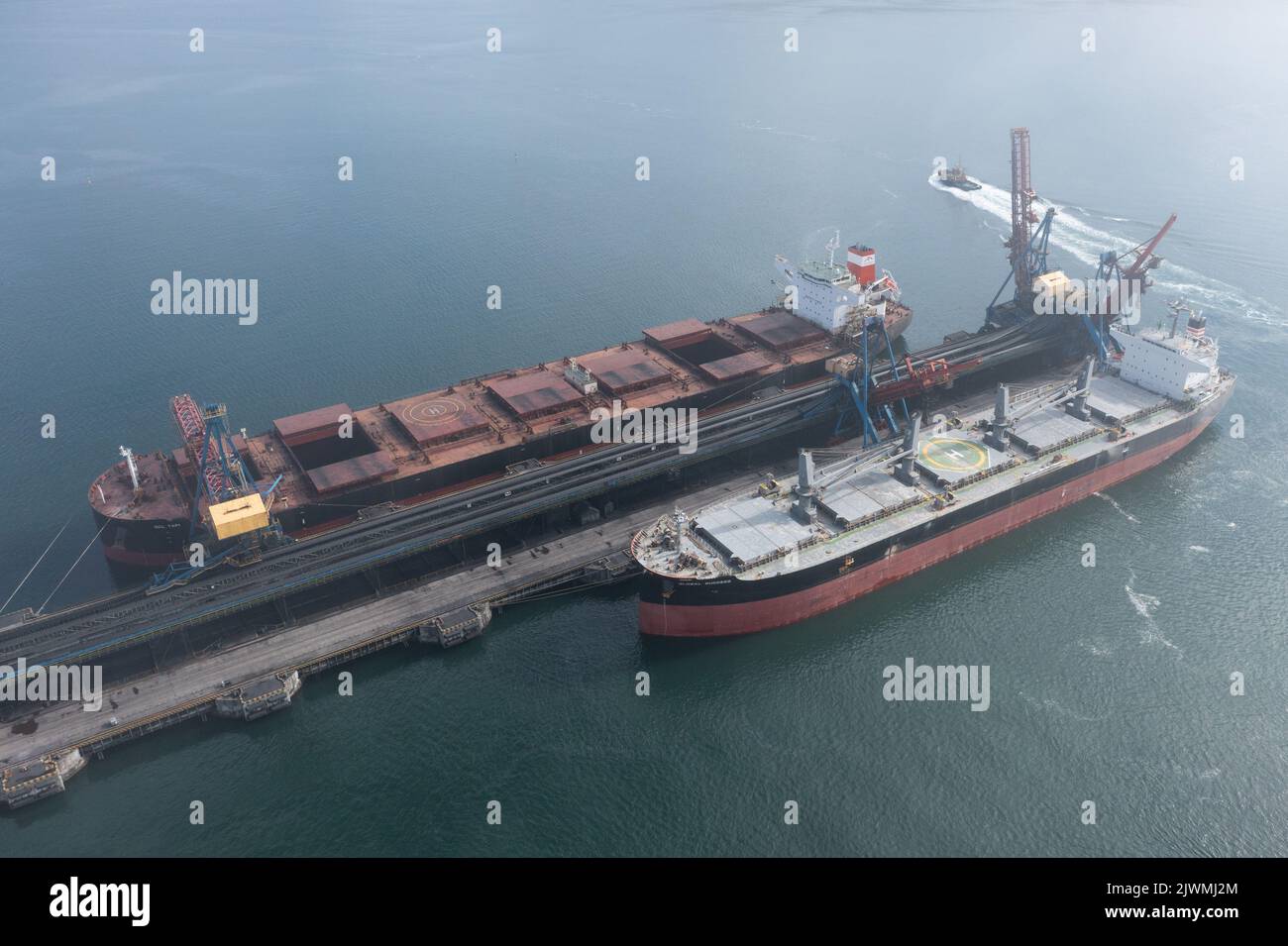 Nakhodka, Russia - July 31, 2022: The sea ships are loaded at a mooring. Stock Photo