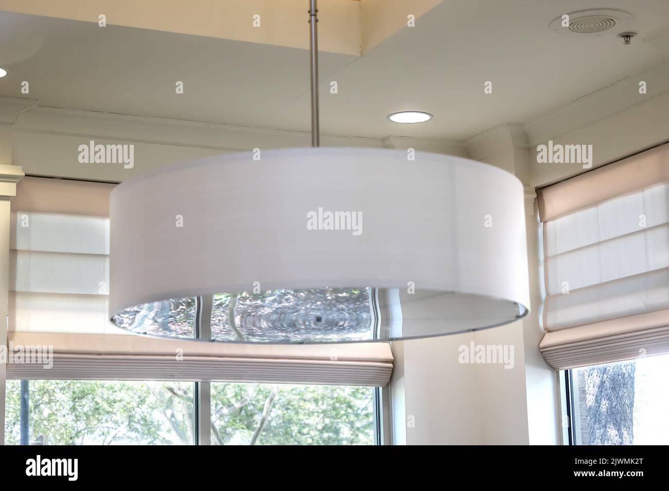 A white drum light fixture interior during the day Stock Photo - Alamy