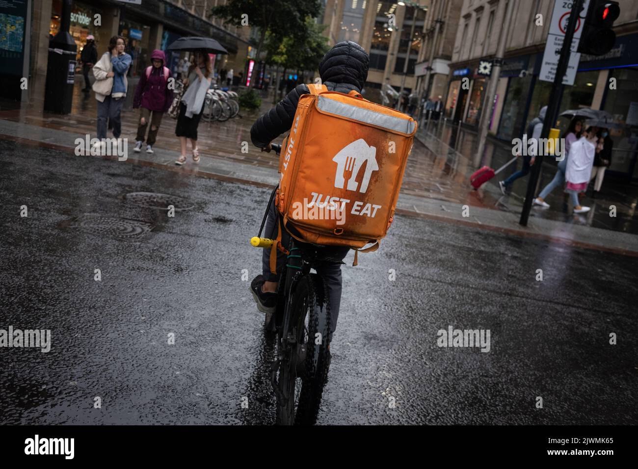 Fast food delivery couriers, for Deliveroo, and Just Eat, in Glasgow, Scotland, 6 September 2022. Stock Photo