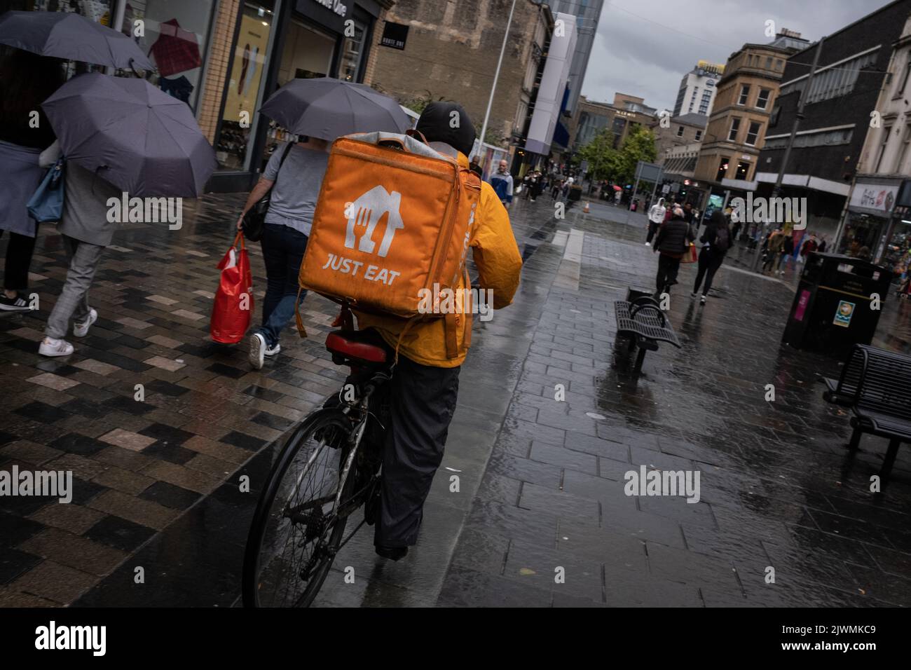 Fast food delivery couriers, for Deliveroo, and Just Eat, in Glasgow, Scotland, 6 September 2022