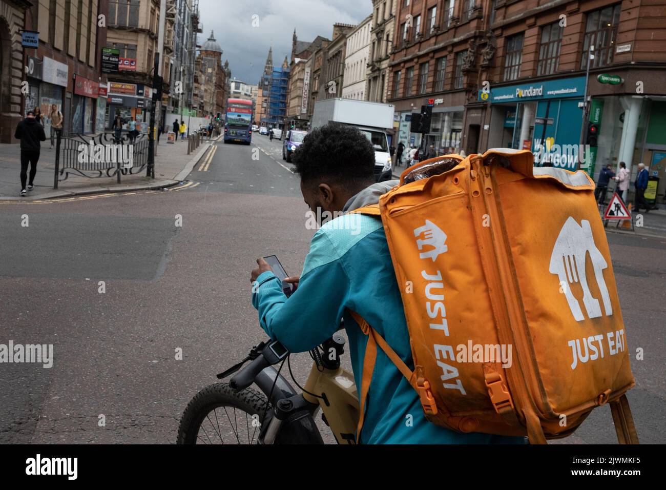 Fast food delivery couriers, for Deliveroo, and Just Eat, in Glasgow, Scotland, 6 September 2022. Stock Photo