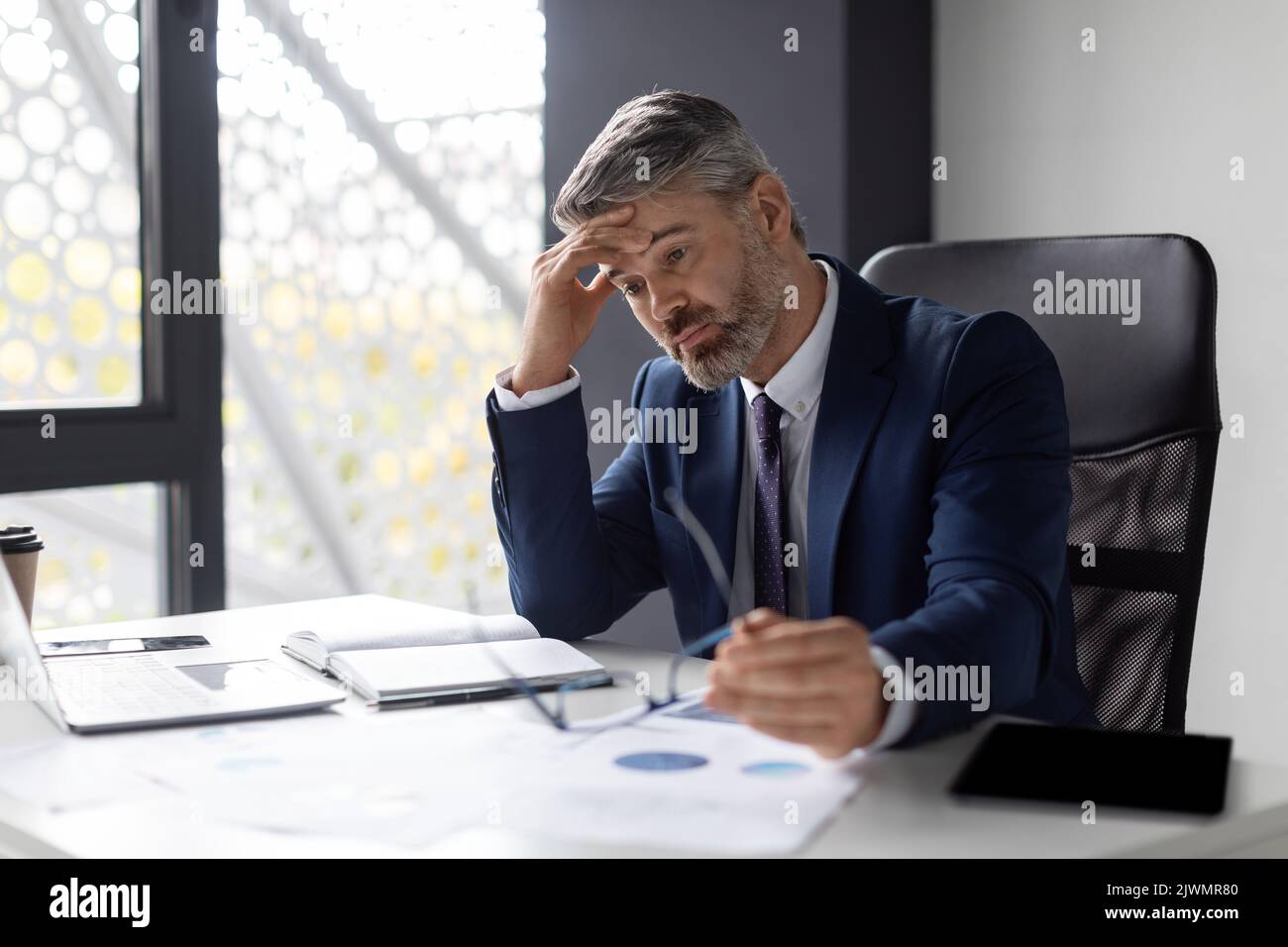 Entrepreneurship Crisis. Depressed Middle Aged Businessman Sitting At Workplace In Office Stock Photo
