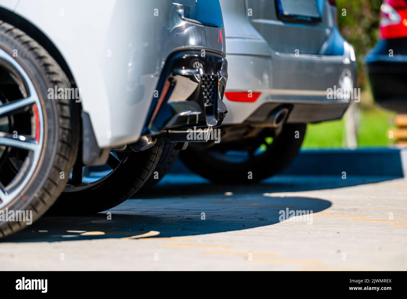 close-up of the wheels and bumpers of a car parked in the yard of a residential house, lower section Stock Photo