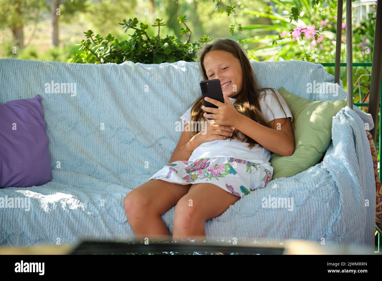 Pretty girl sitting on balcony hi-res stock photography and images - Alamy