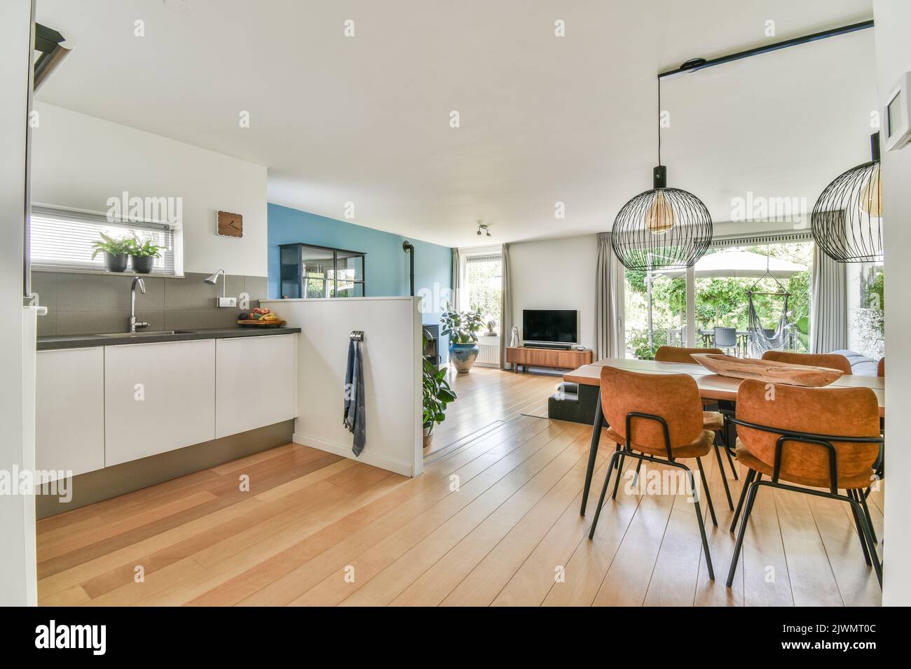 Contemporary luxury design of living room with kitchen and dining table near window Stock Photo