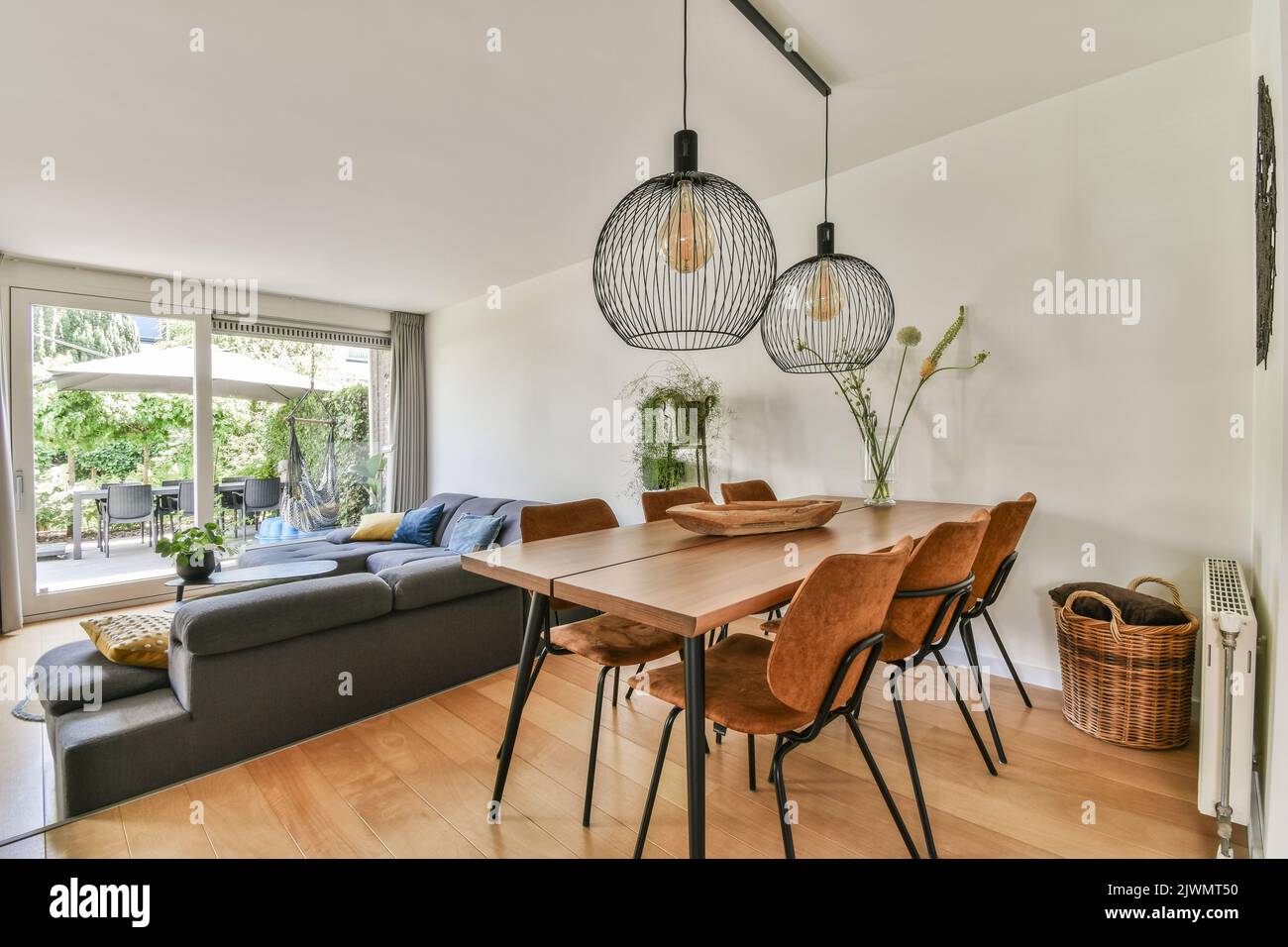 Contemporary luxury design of living room with kitchen and dining table near window Stock Photo