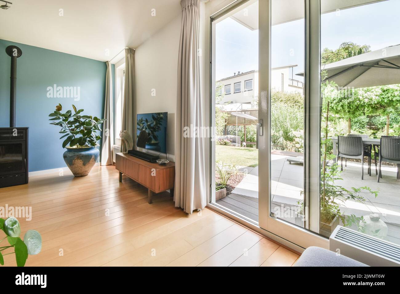 Contemporary luxury design of living room with kitchen and dining table near window Stock Photo