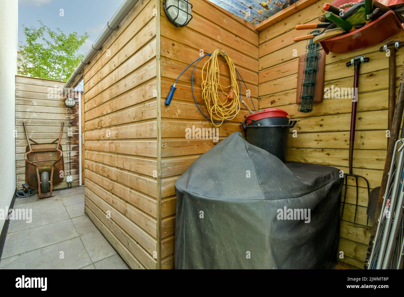 Backyard of house where storing garden tools to take care of garden Stock Photo Alamy