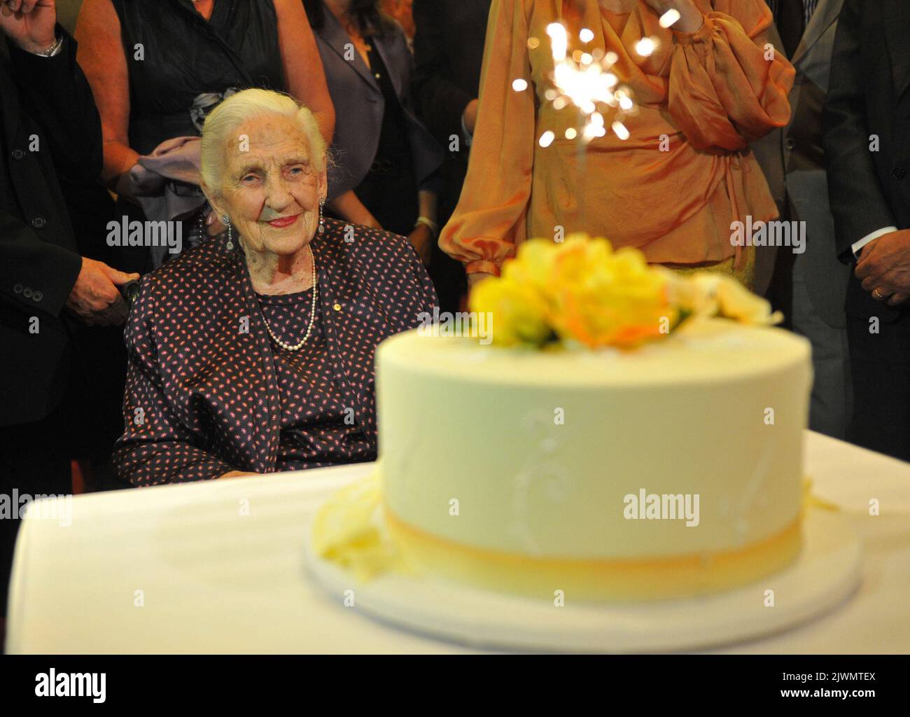 Dame Elisabeth Murdoch looks at her 102nd birthday cake at the