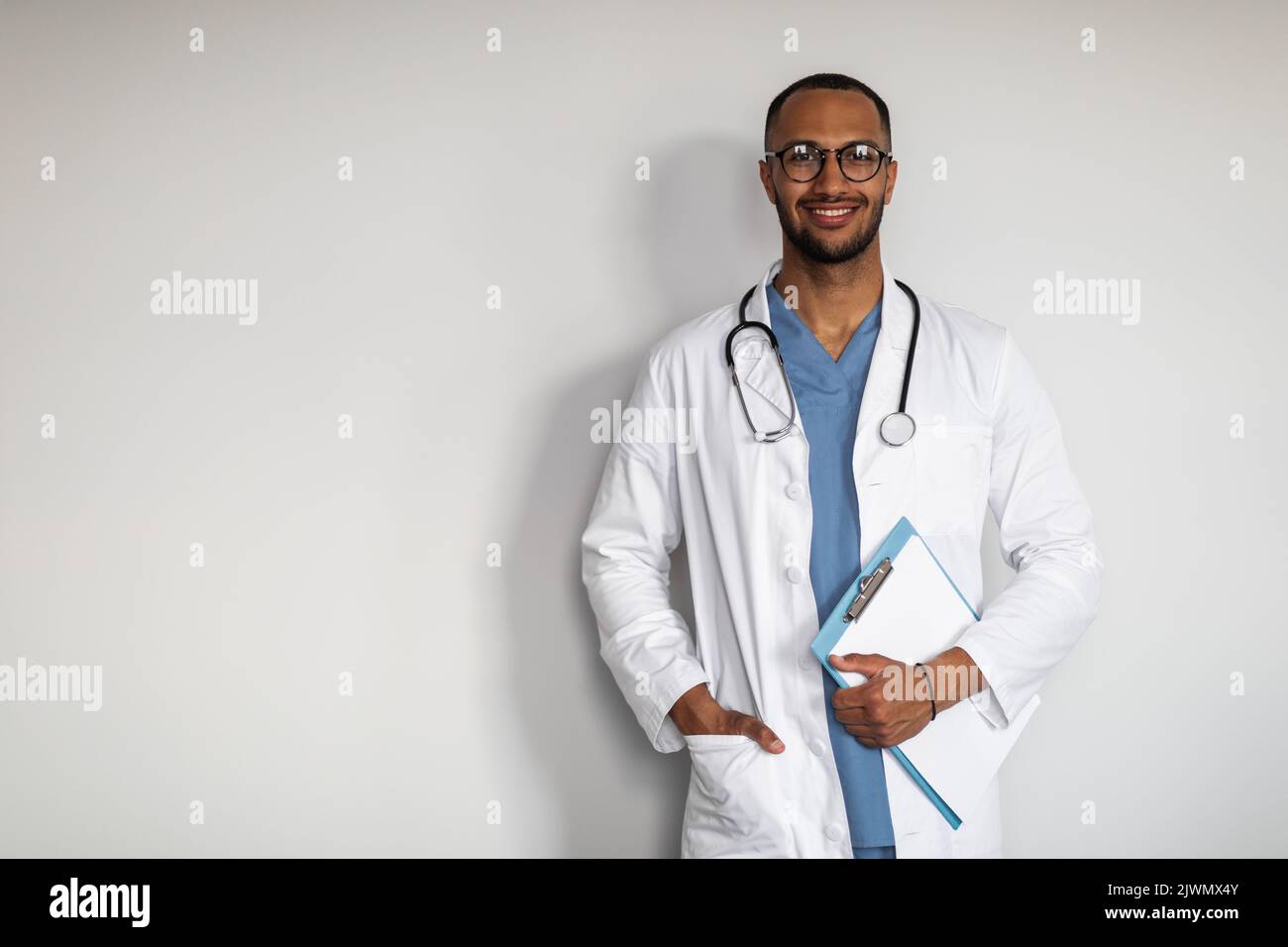 Portrait of cheerful arab doctor holding medical chart Stock Photo