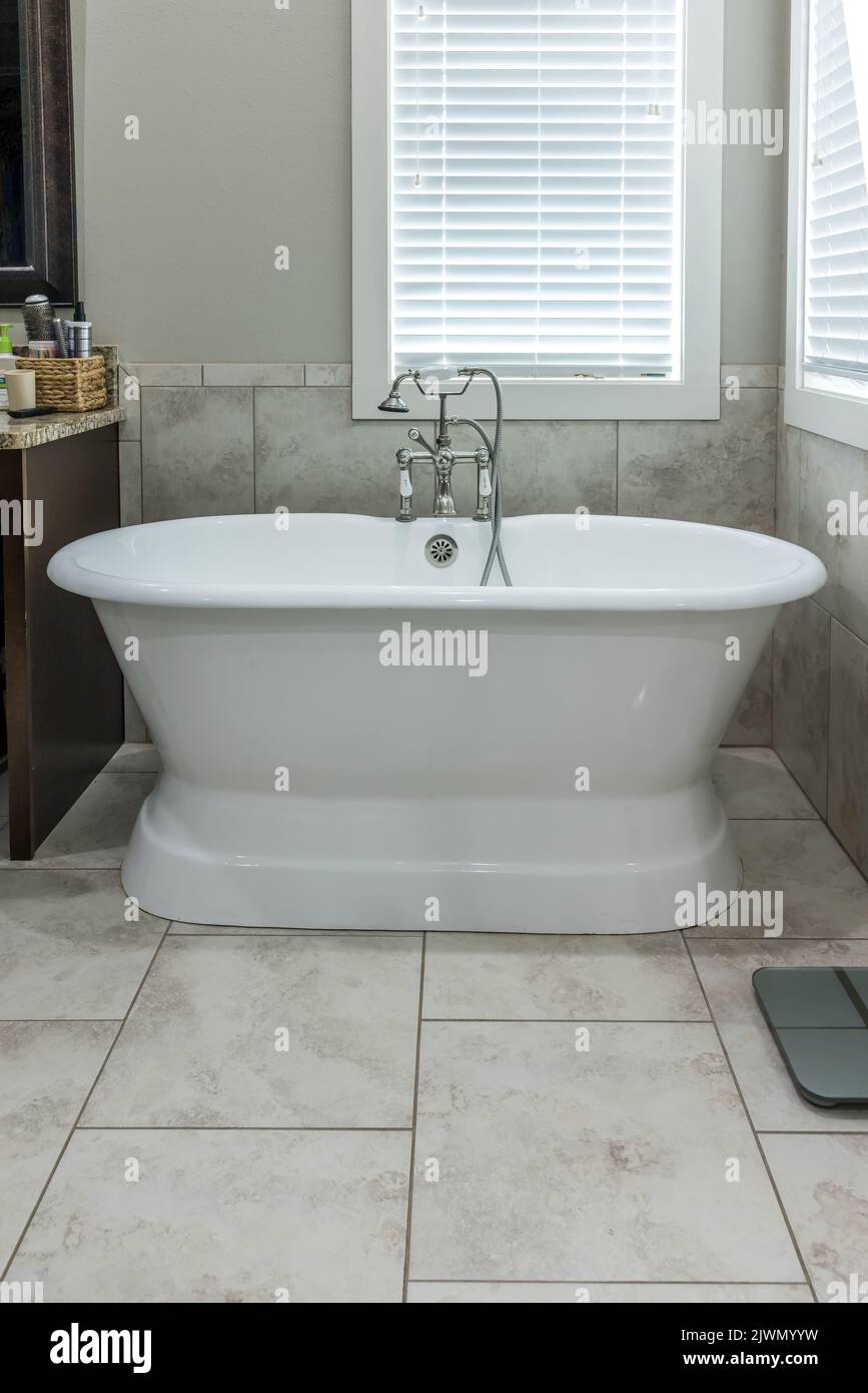 Master bathroom freestanding bathtub in a tiled master bathroom Stock Photo