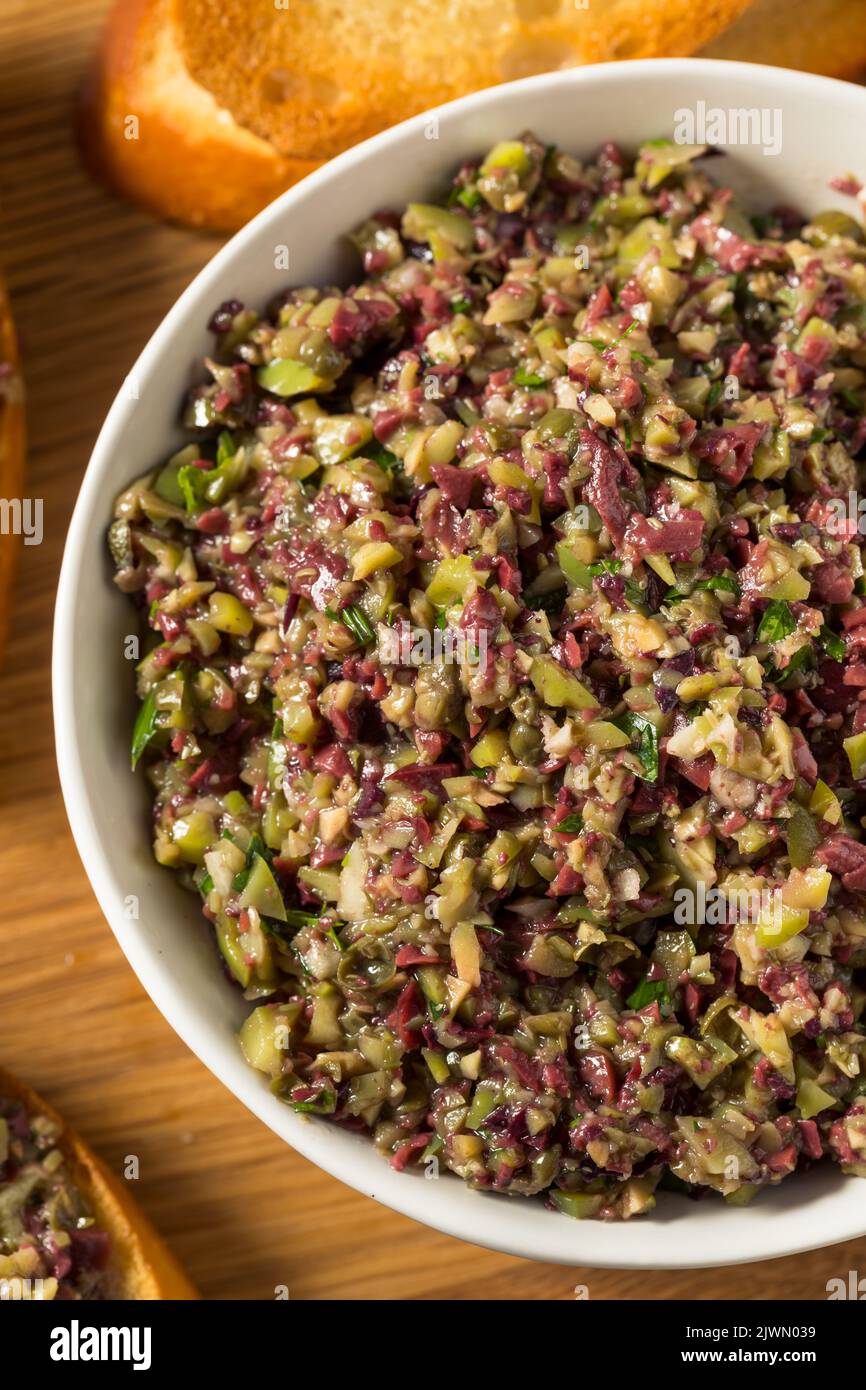 Homemade Mixed Olive Tapenade Appetizer with Toasted Bread Stock Photo