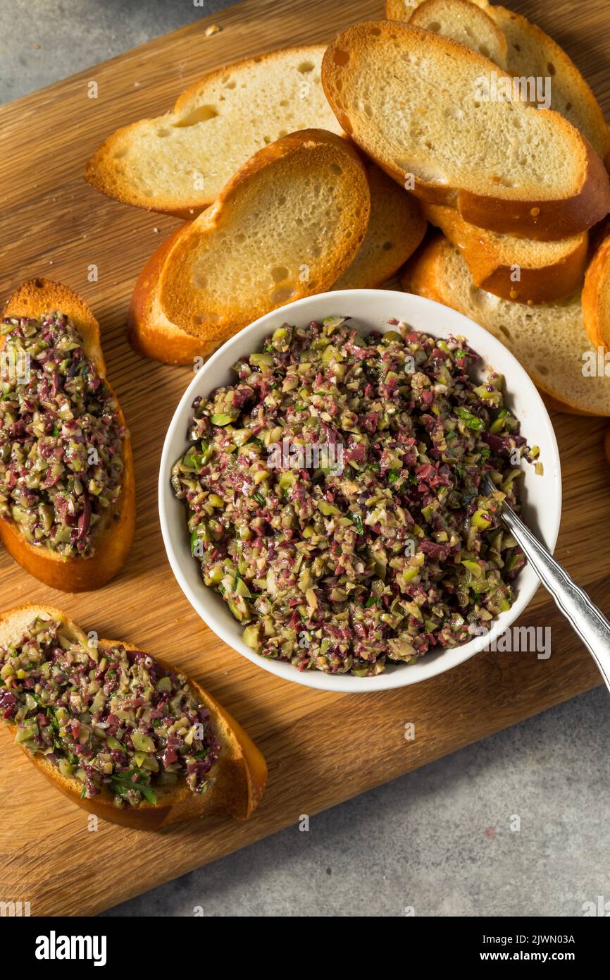 Homemade Mixed Olive Tapenade Appetizer with Toasted Bread Stock Photo