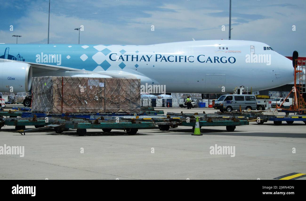 A Cathay Pacific Boeing 7478F freighter sitting at the cargo terminal