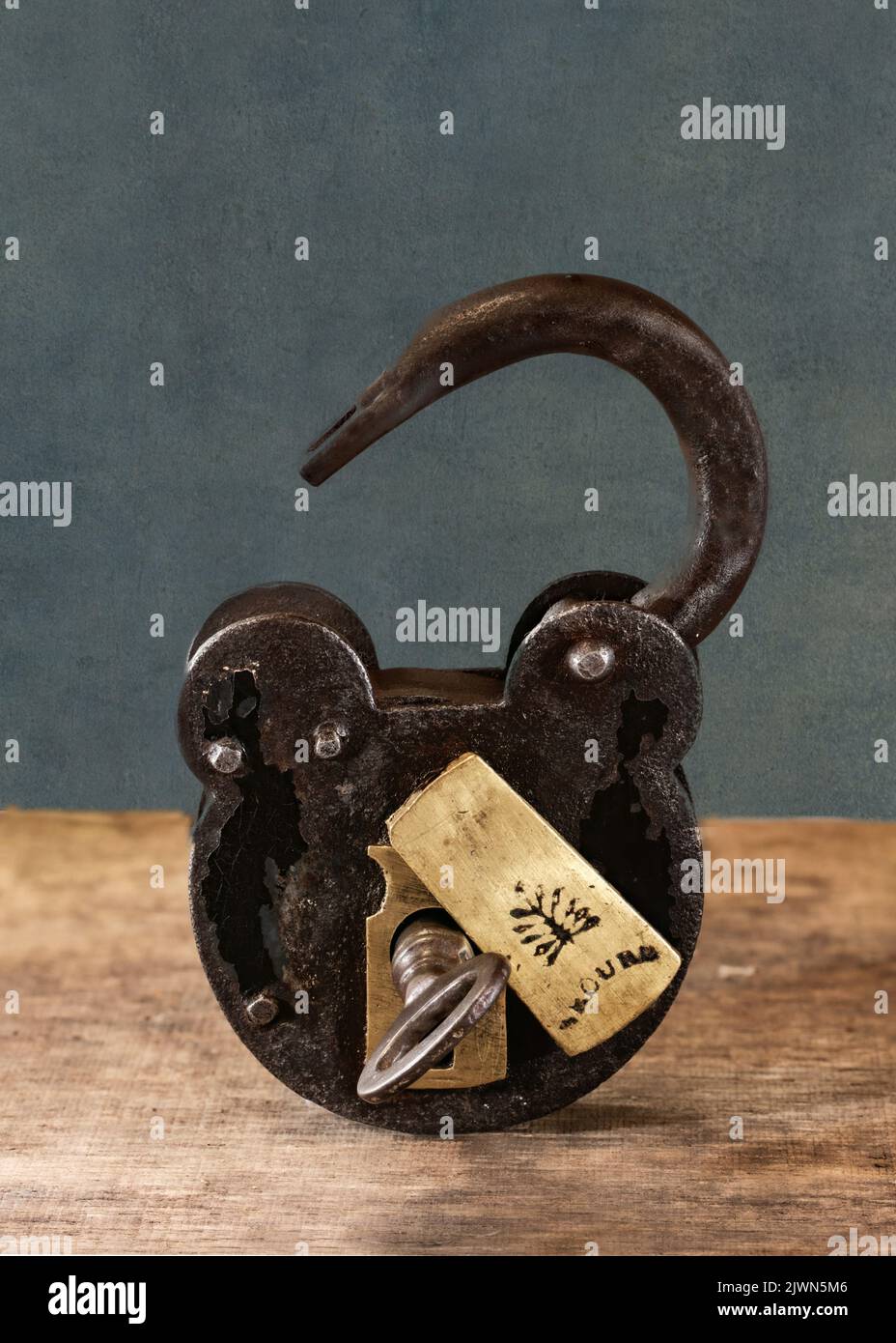 A close up still life image of an old fashioned padlock and key in the open position Stock Photo