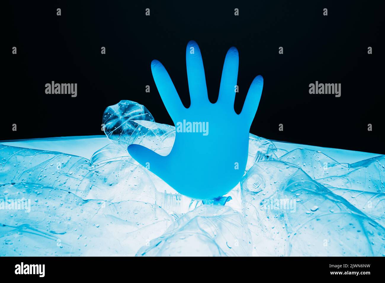 stop pollution save earth glove plastic bottles Stock Photo
