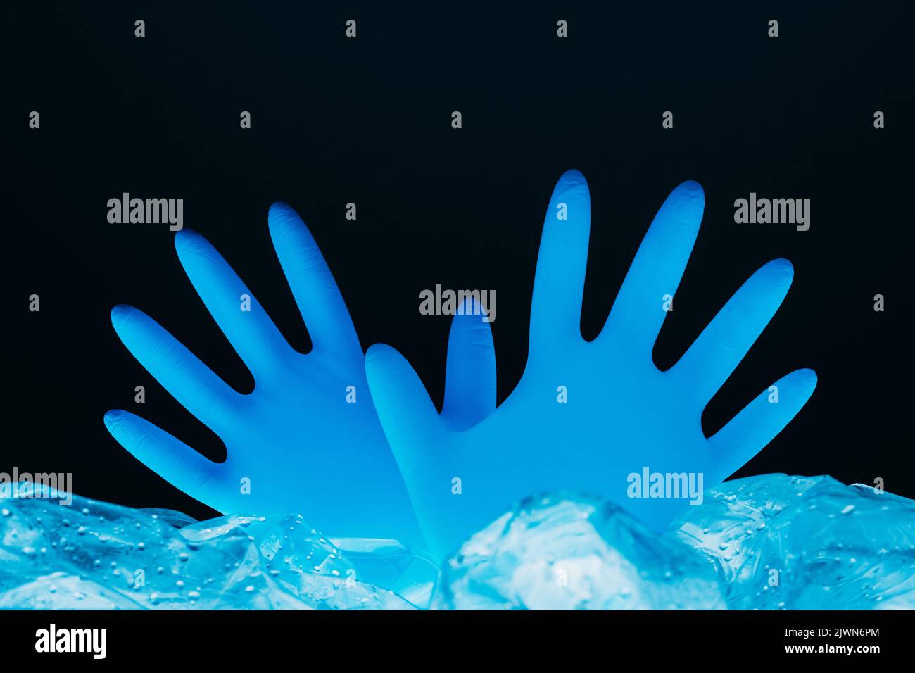 ocean pollution ecology problem blue hand gloves Stock Photo