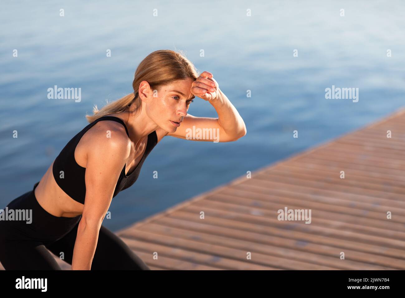 Portrait Of Exhausted Sporty Lady Catching Breath After Outdoor Training Stock Photo