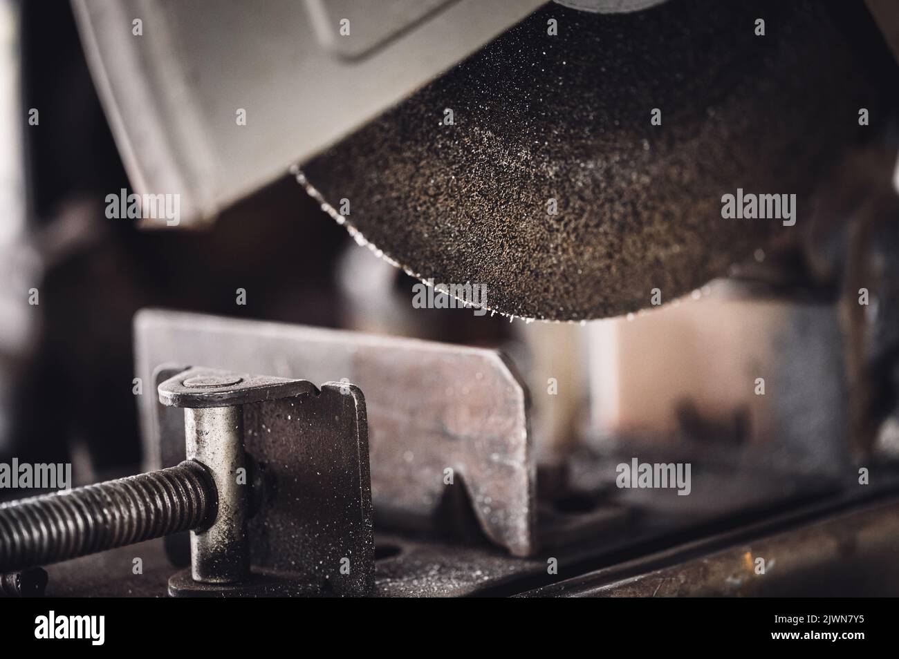 Selective focus on chop saw abrasive blade used for cutting metal Stock