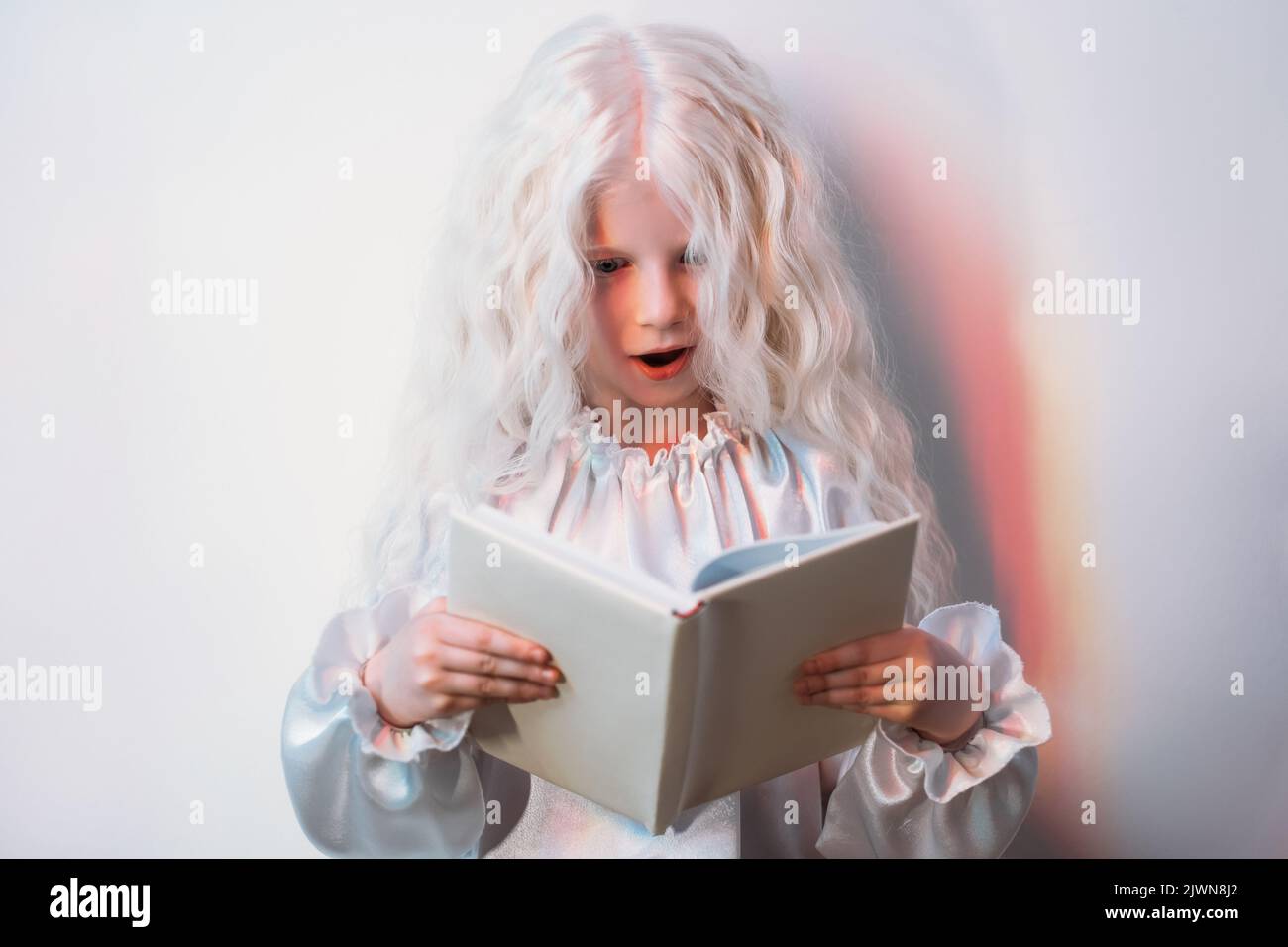 kid curiosity amazing discovery blonde girl book Stock Photo