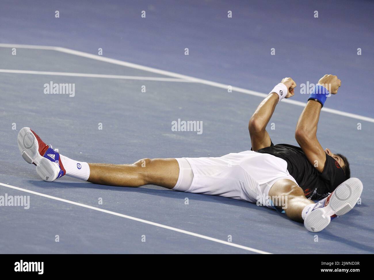 Novak Djokovic of Serbia collapses on court after defeating Rafael