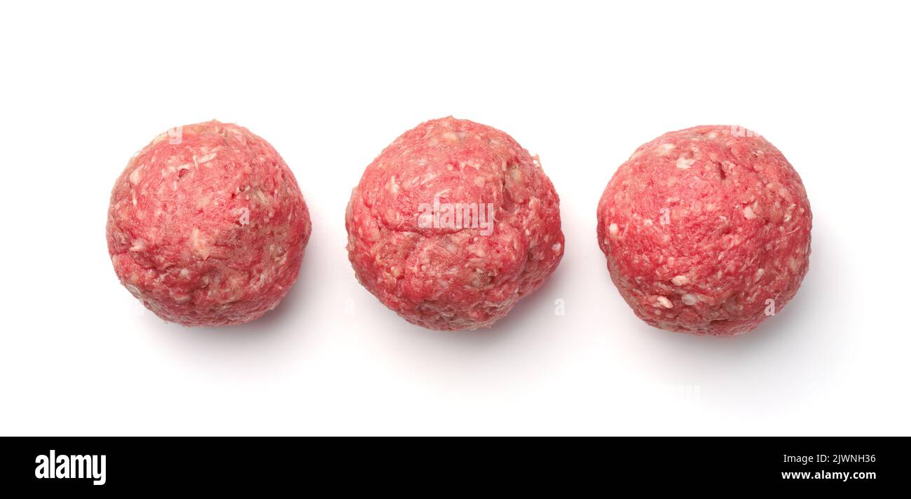 Top view of  three fresh raw homemade meatballs isolated on white Stock Photo