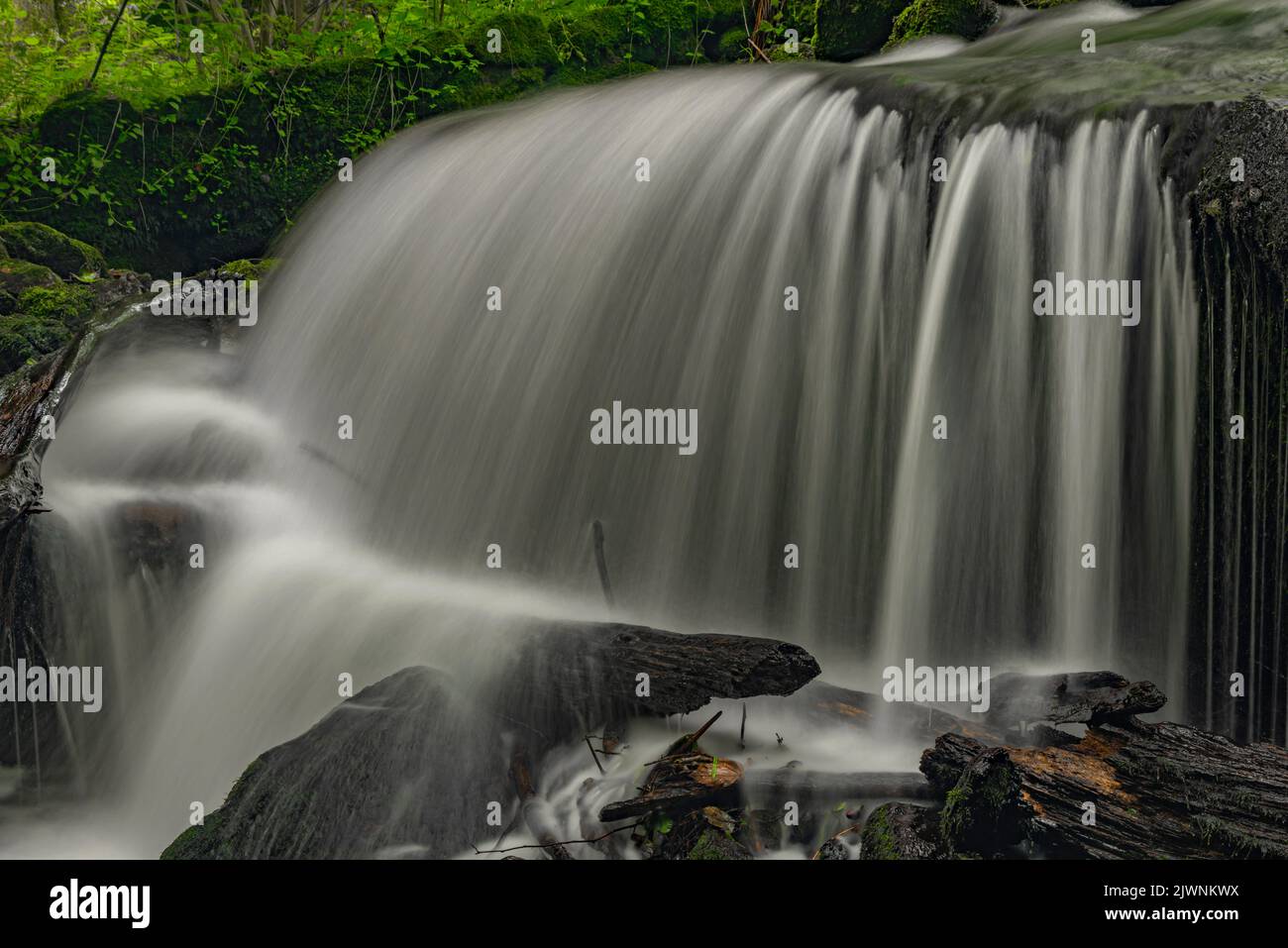 Waterfall under floodgate near Vyssi Brod town in cloudy summer fresh day Stock Photo