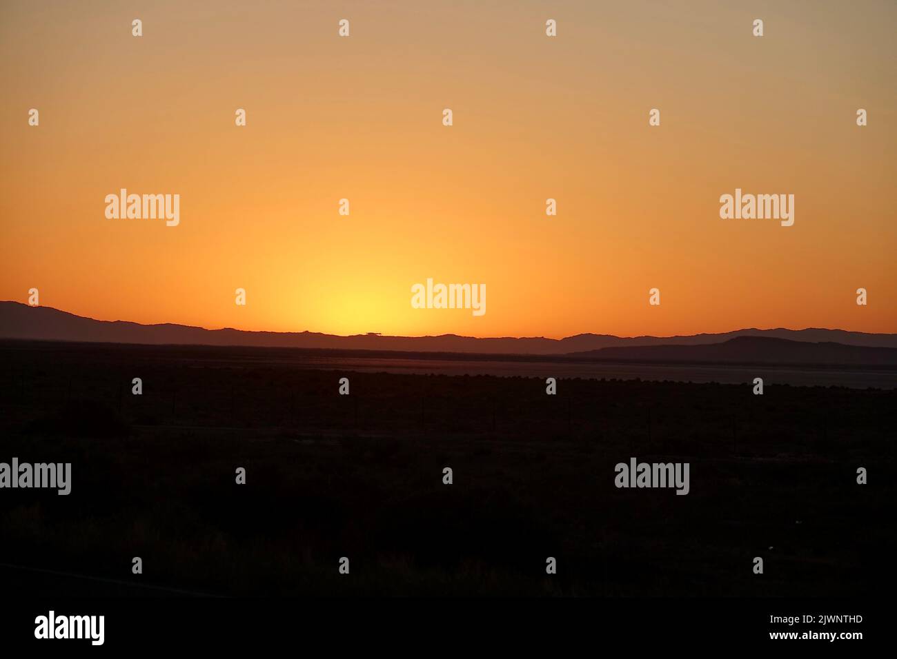 sun rising above the desert foothills at dawn Stock Photo - Alamy