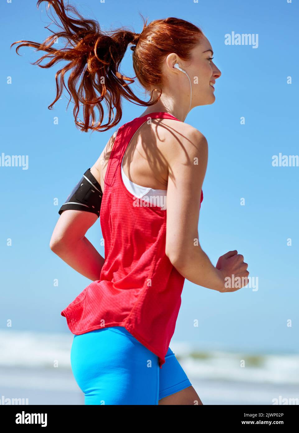 Happiness is... Fitness on the beach. a young woman running on the beach Stock Photo Alamy