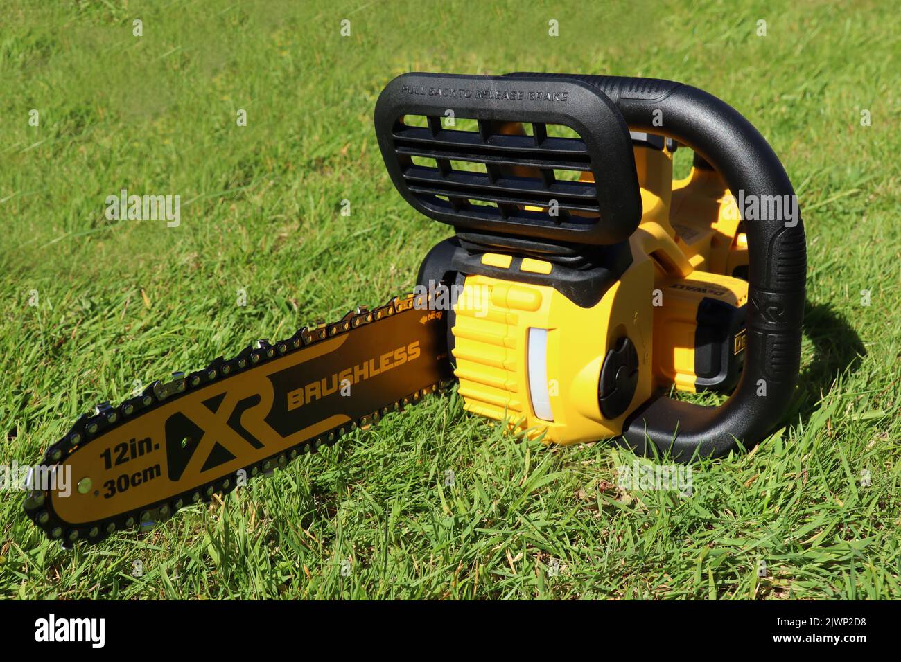 EXETER, DEVON, ENGLAND JUNE 15TH 2021 Dewalt 18 volt cordless chainsaw on the lawn Stock