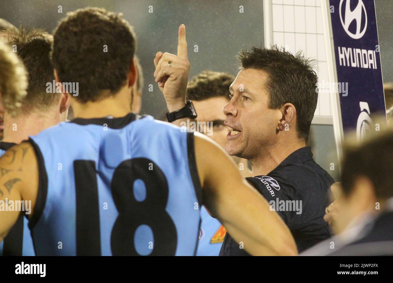 Carlton coach Brett Ratten talks to his team at quarter time during ...