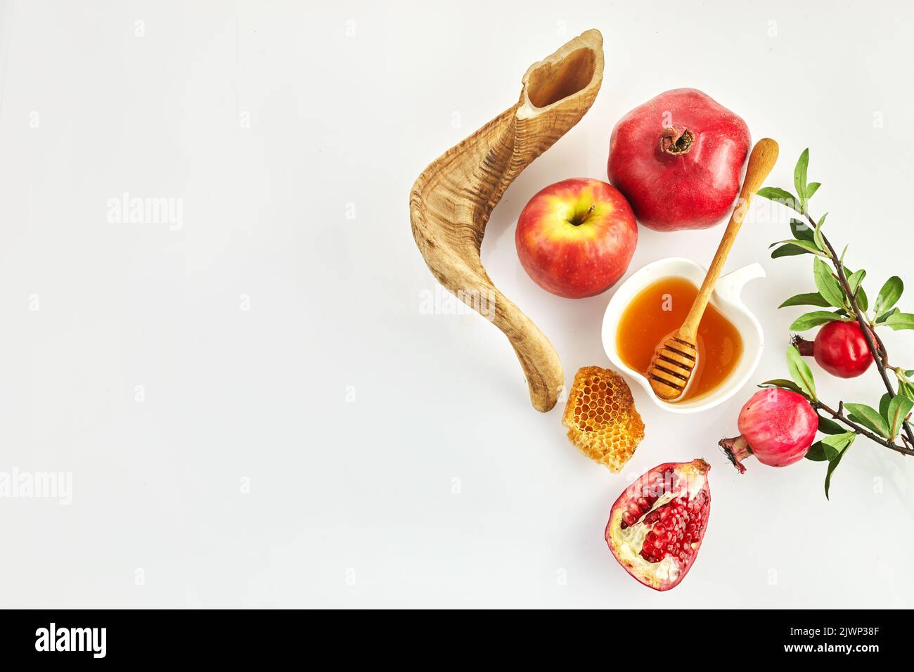 Rosh hashanah, jewish New Year holiday concept. Pomegranate, apples and honey traditional products for celebration Stock Photo