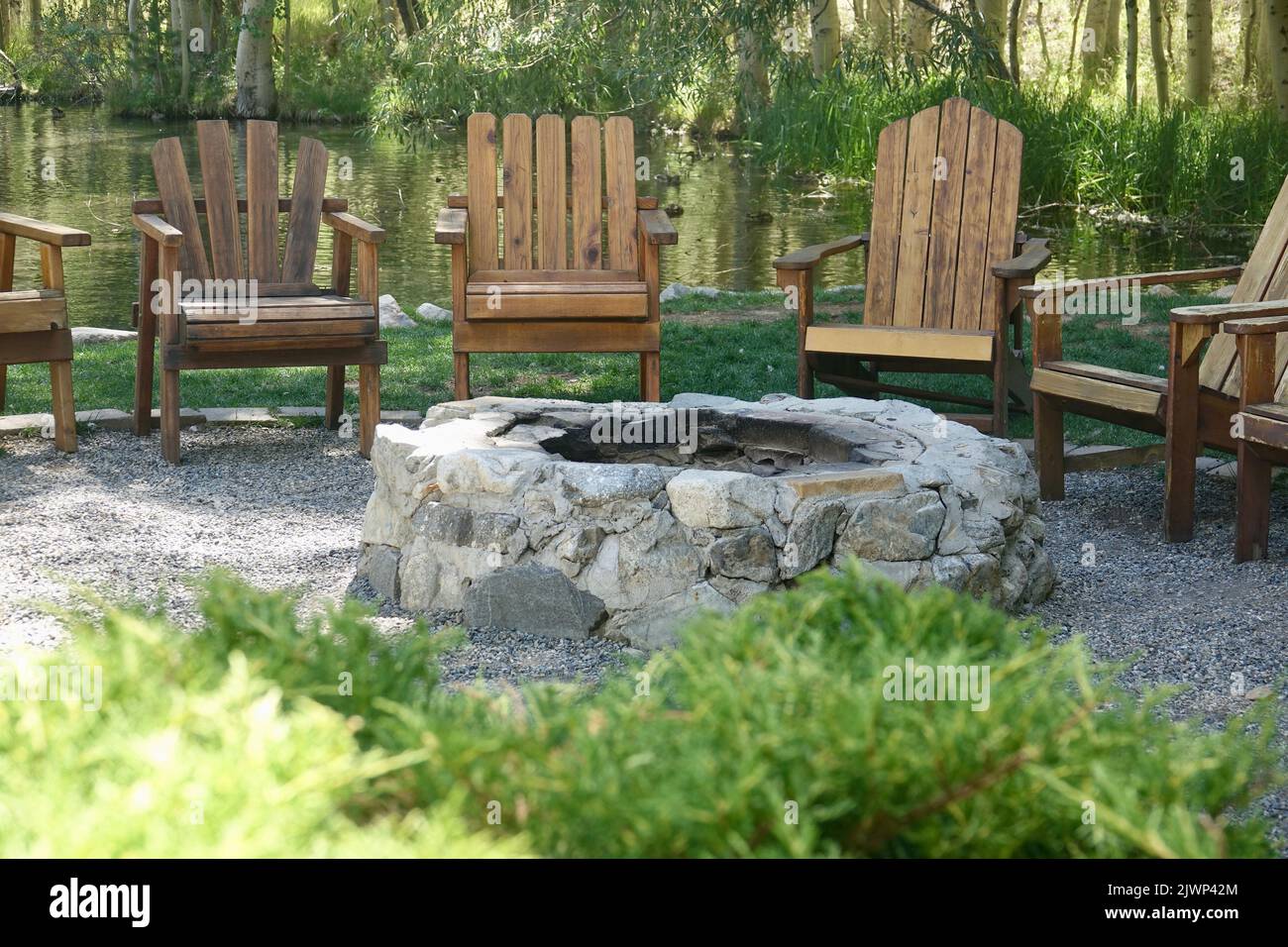 circle of Adirondack chairs around the fire pit Stock Photo
