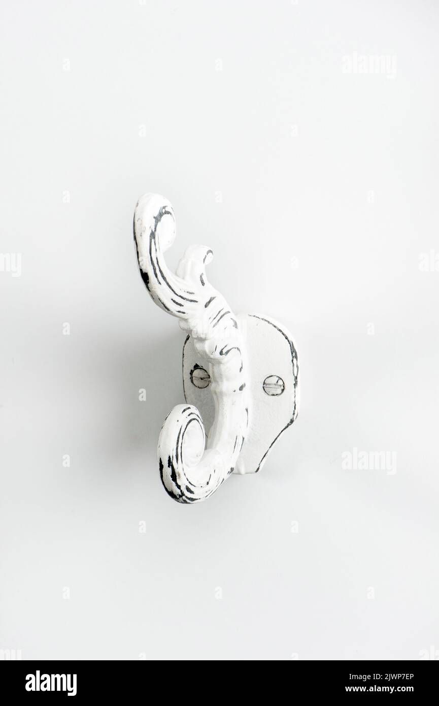 Painted iron wall hook for hanging clothes. Stock Photo