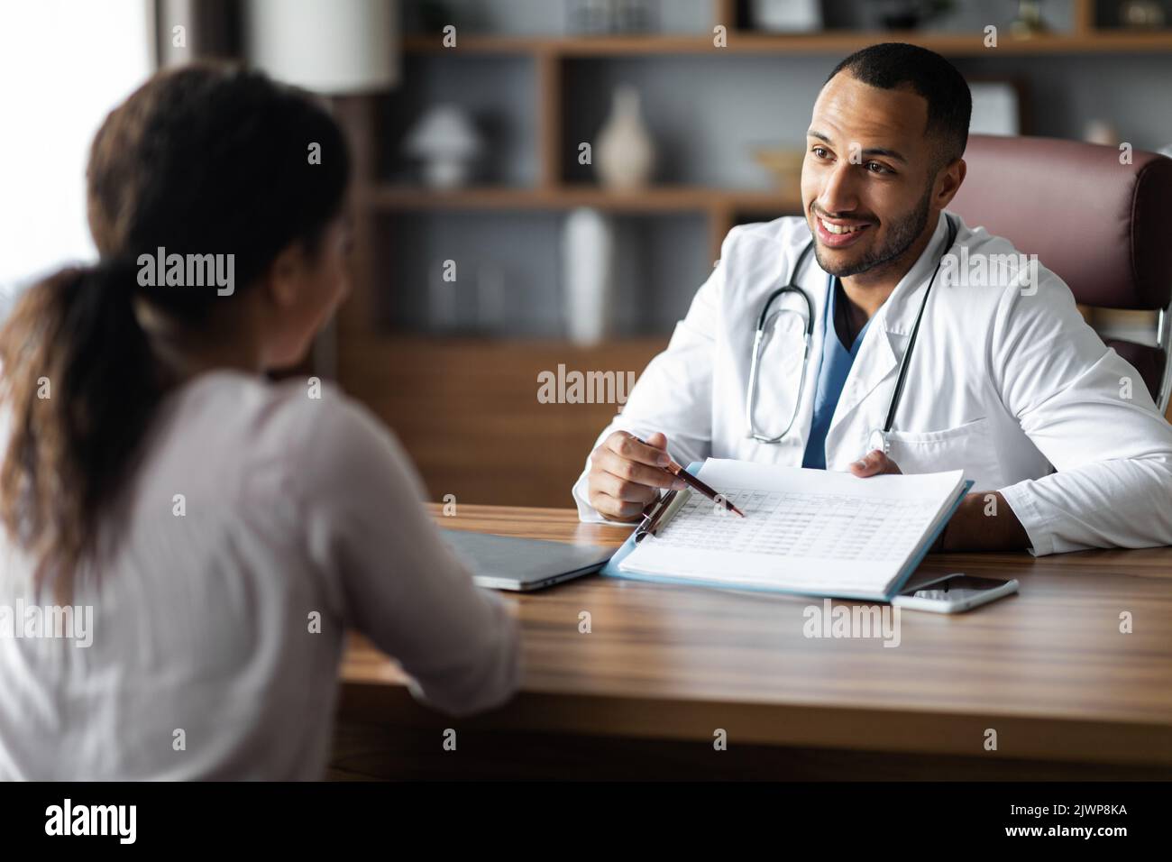 Friendly african american doctor having conversation with female ...