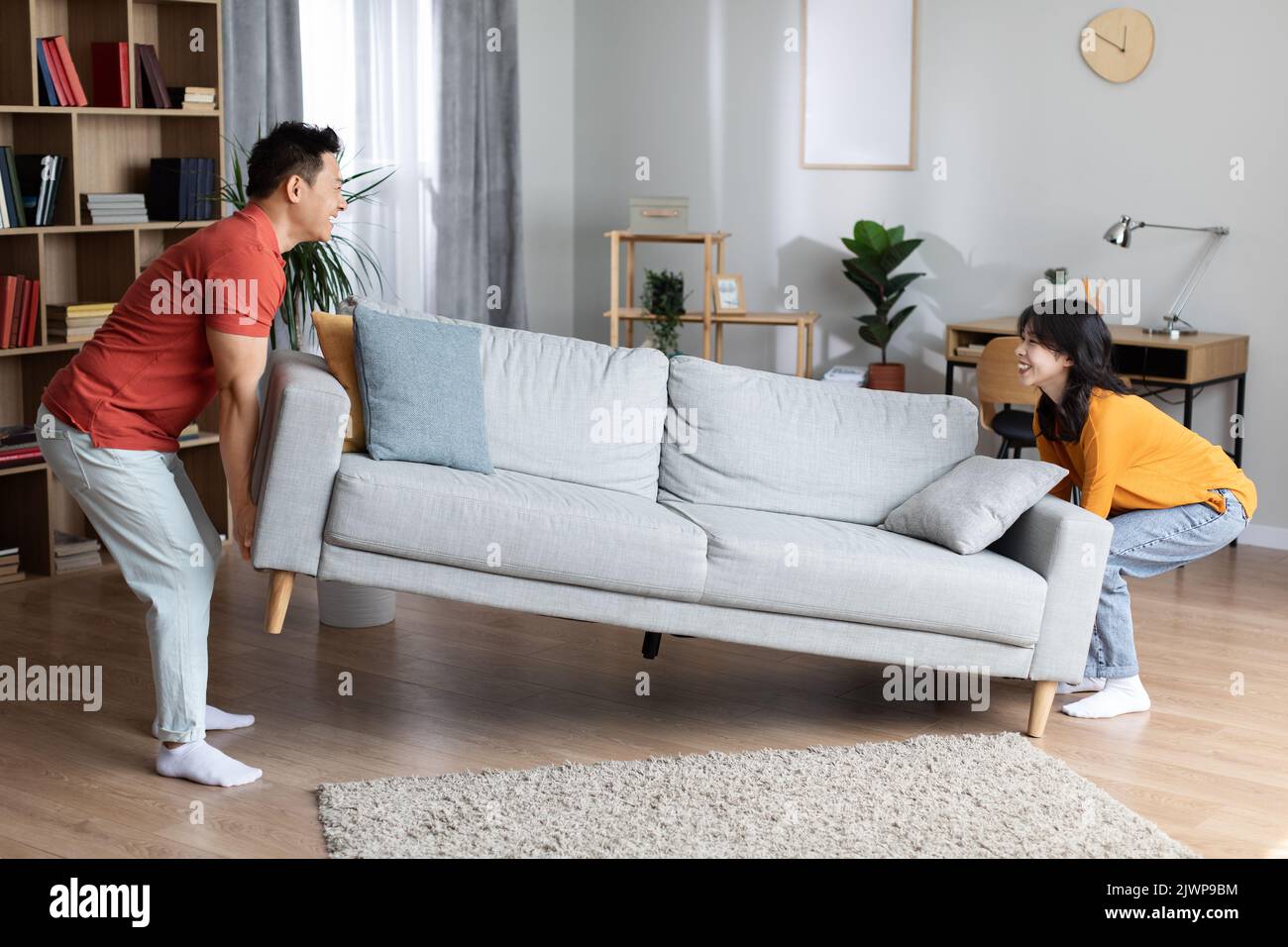 Happy asian family moving furniture at their new house Stock Photo Alamy